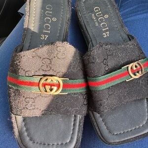 Gucci Black Slides with Gold Accents